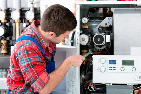 Heating technician repairing boiler controls in Redwood City