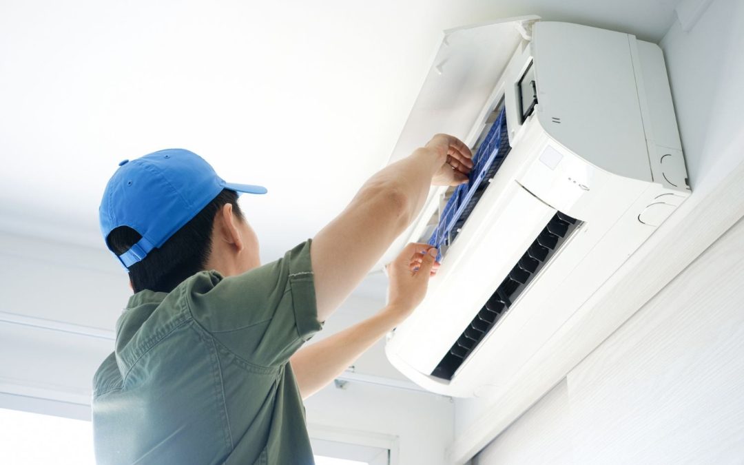 HVAC technician servicing a ductless mini split in Redwood City