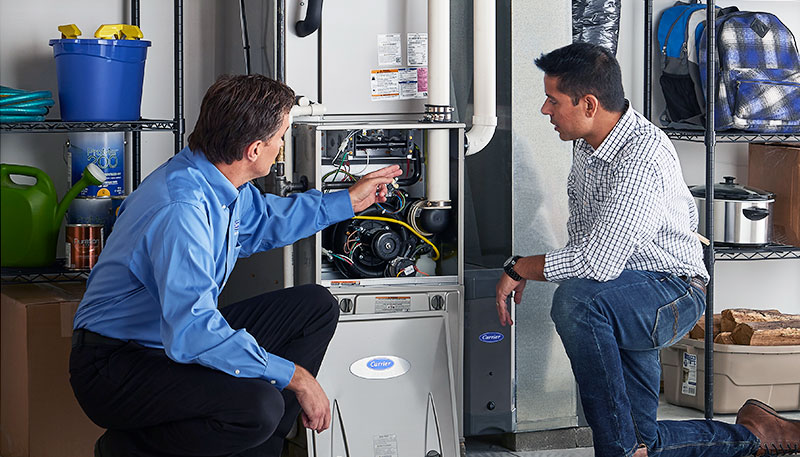 Technician evaluating a furnace for repair or replacement in Redwood City