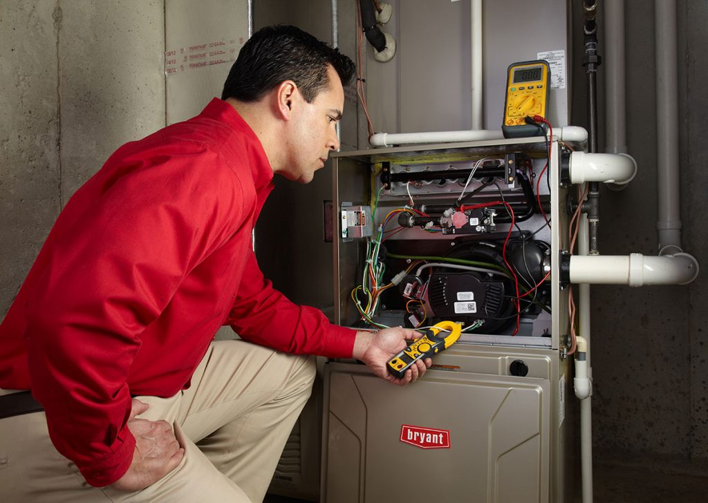 Heating technician diagnosing a furnace repair in Redwood City