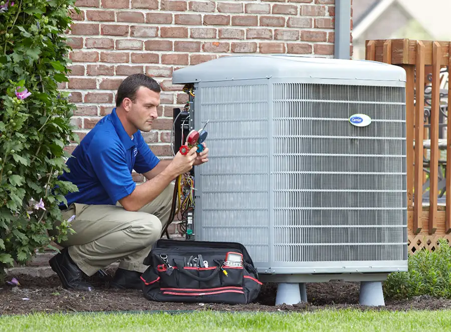 HVAC technician inspecting an outdoor AC unit in Redwood City