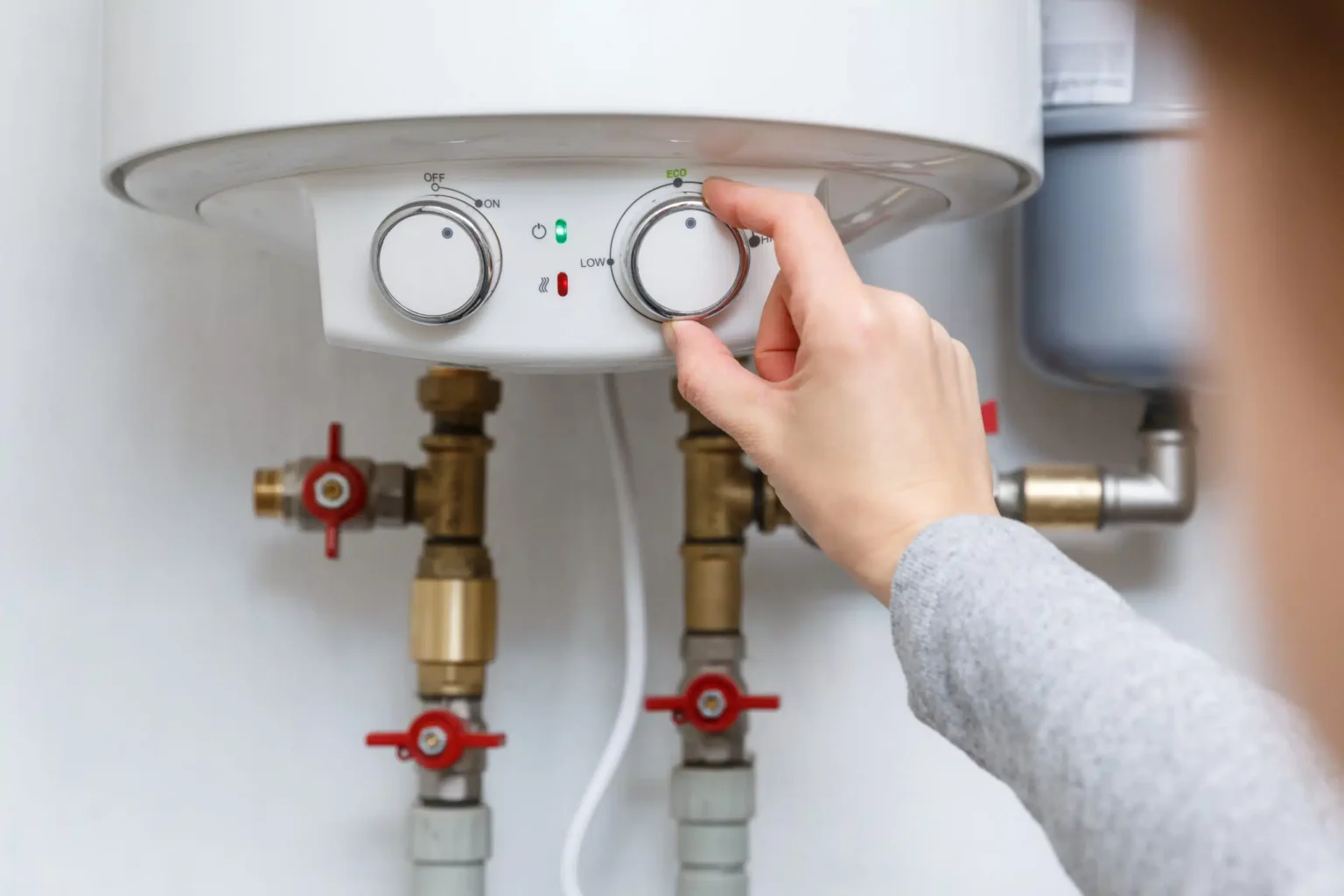 Technician adjusting a water heater in Redwood City